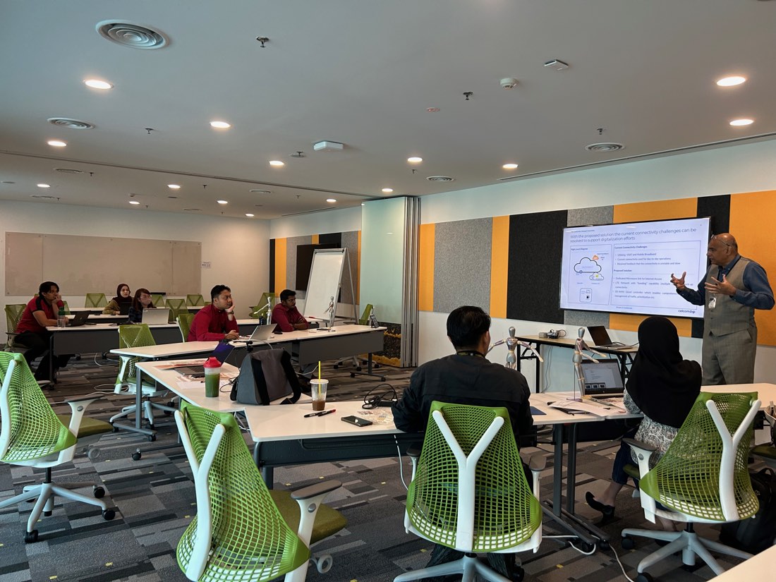 A facilitator leading a learning session in a training room