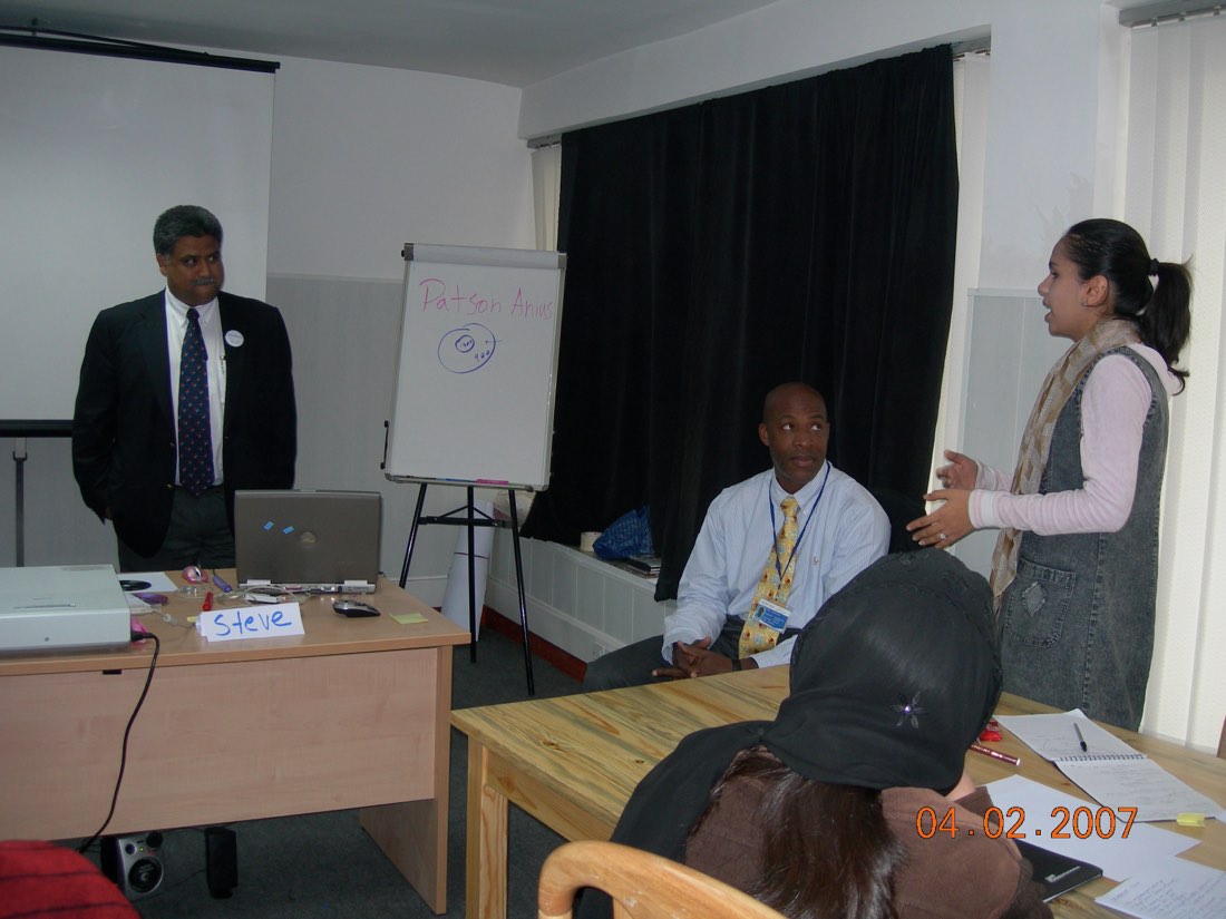 A participant presenting at a flipchart in an early workshop