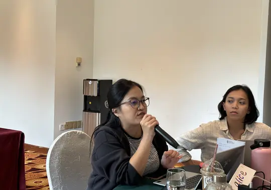 A participant speaking into the microphone during a discussion