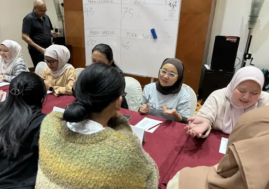 Participants laughing during a table discussion