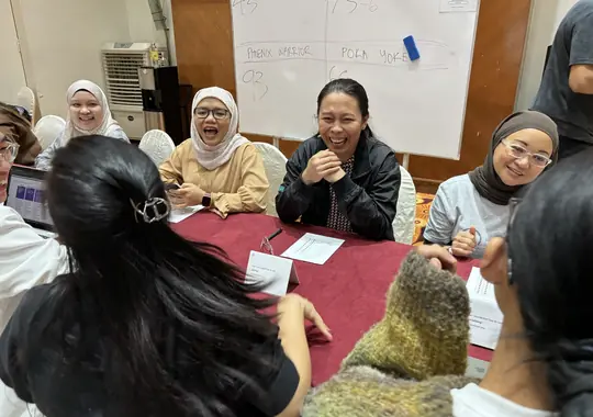 A table of participants sharing a laugh