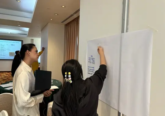 Participants writing up ideas on a flipchart