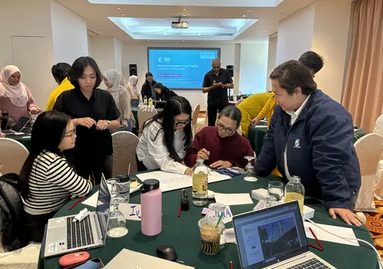 Participants working together at a busy table