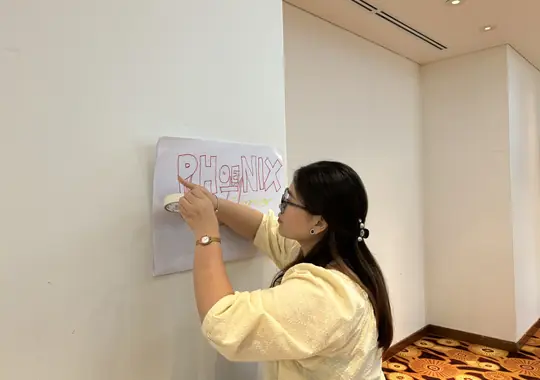 A participant writing up her team name