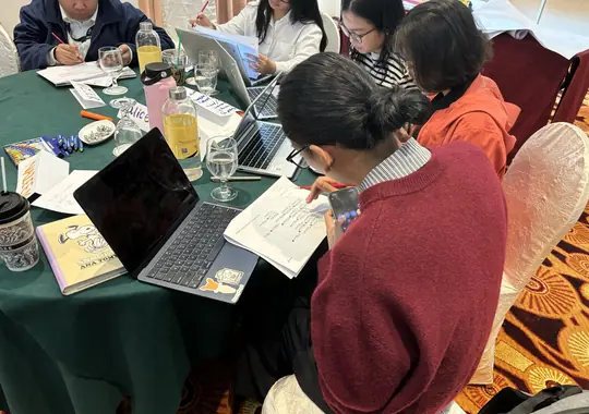 A participant taking notes at her laptop
