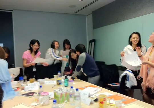 Participants moving around a table during a group exercise